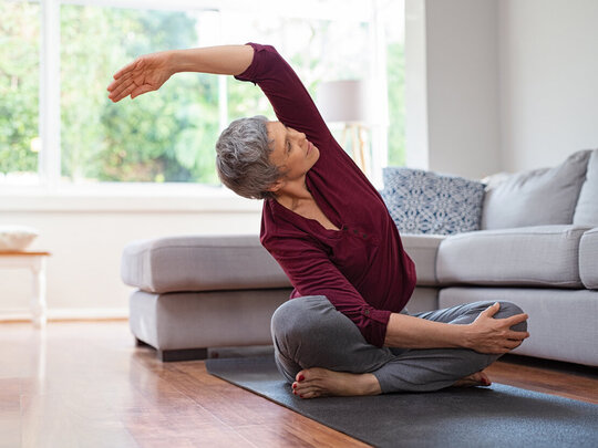 Bild: Seniorin macht Yoga zuhause